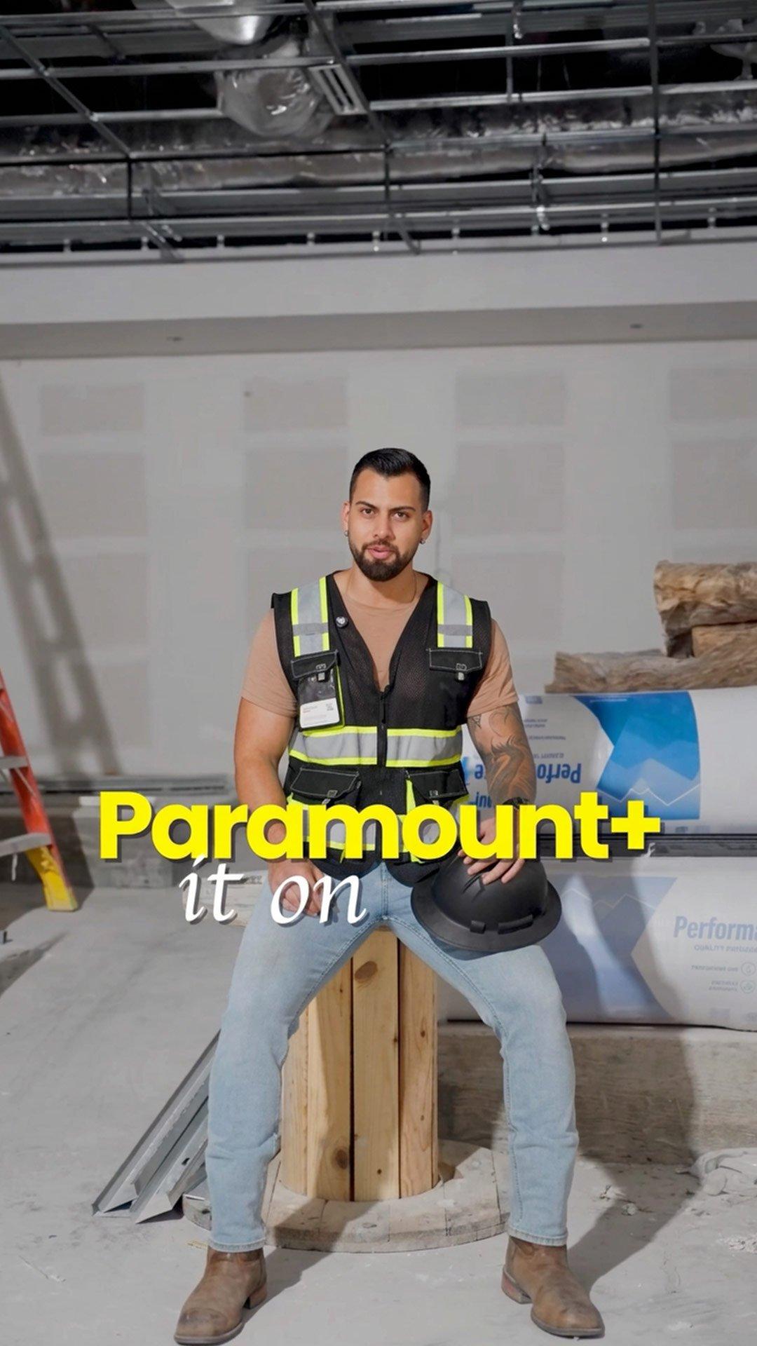 Construction worker seated on a wooden spool holding a hard hat, with “Paramount+ it on” text overlaid.